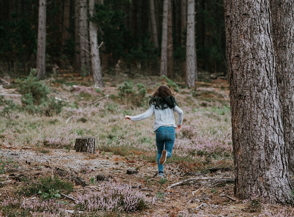 Child running through the woods