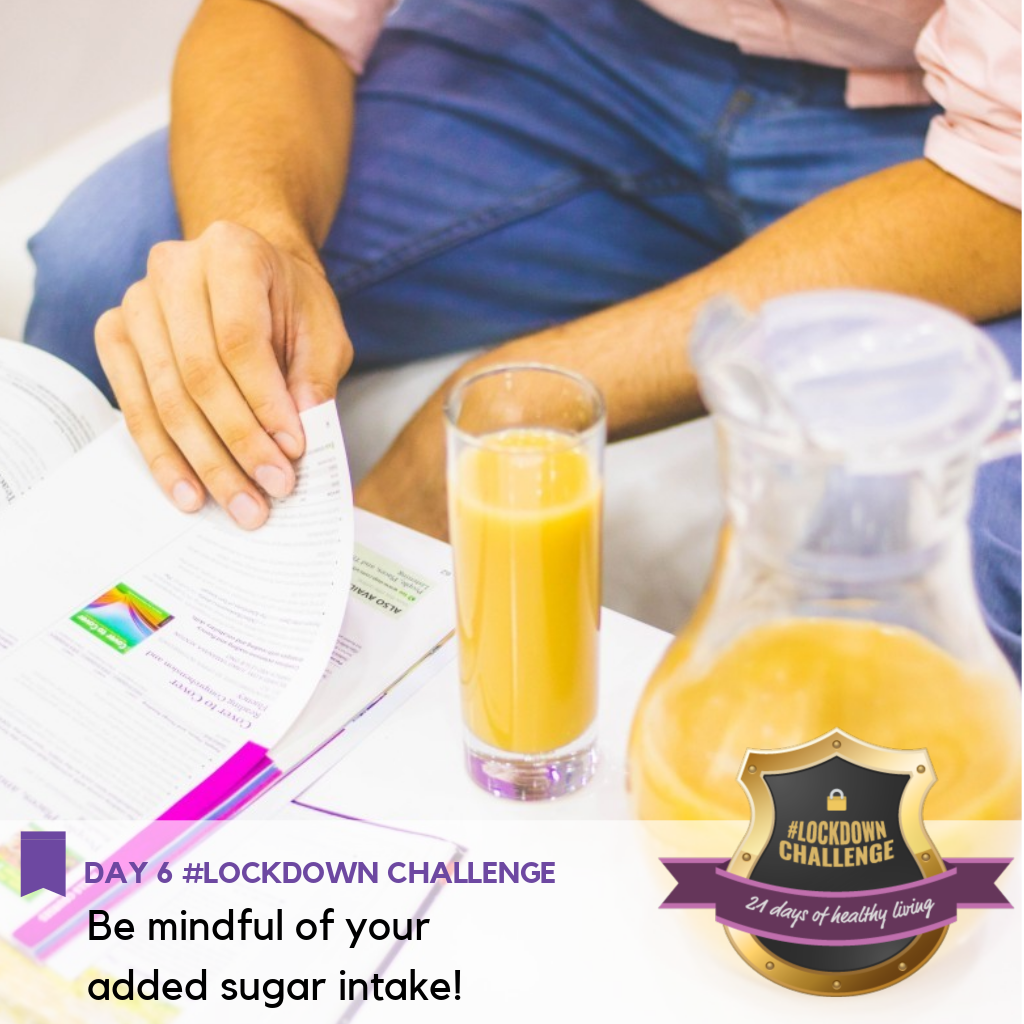 A man reading a book with a glass of orange juice by his side