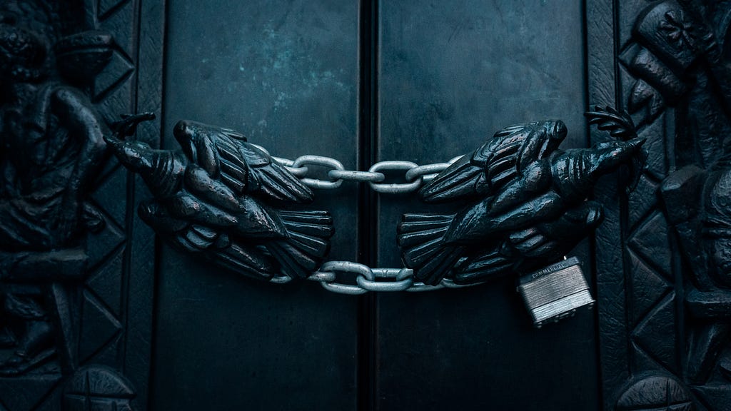 This photo shows a door with very heavy chains and a padlock. The door is intended to represent a protected web application that the user needs to log into before being able to use it.