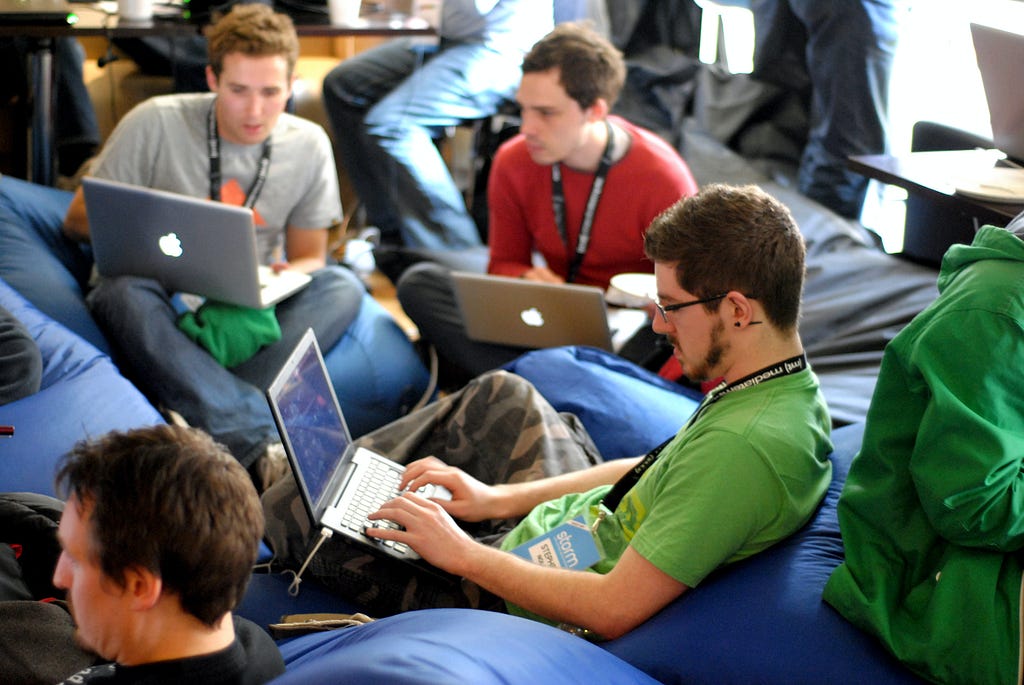 pic of 3 young men working on their laptops and networking together