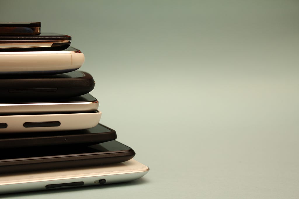 Stack of phones and tablets of different sizes.