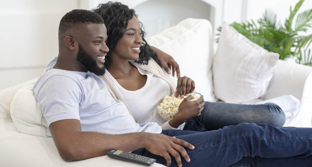 Couple watching tv on couch
