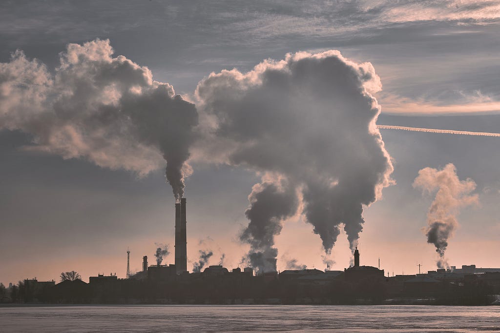 A series of towers producing smoke.