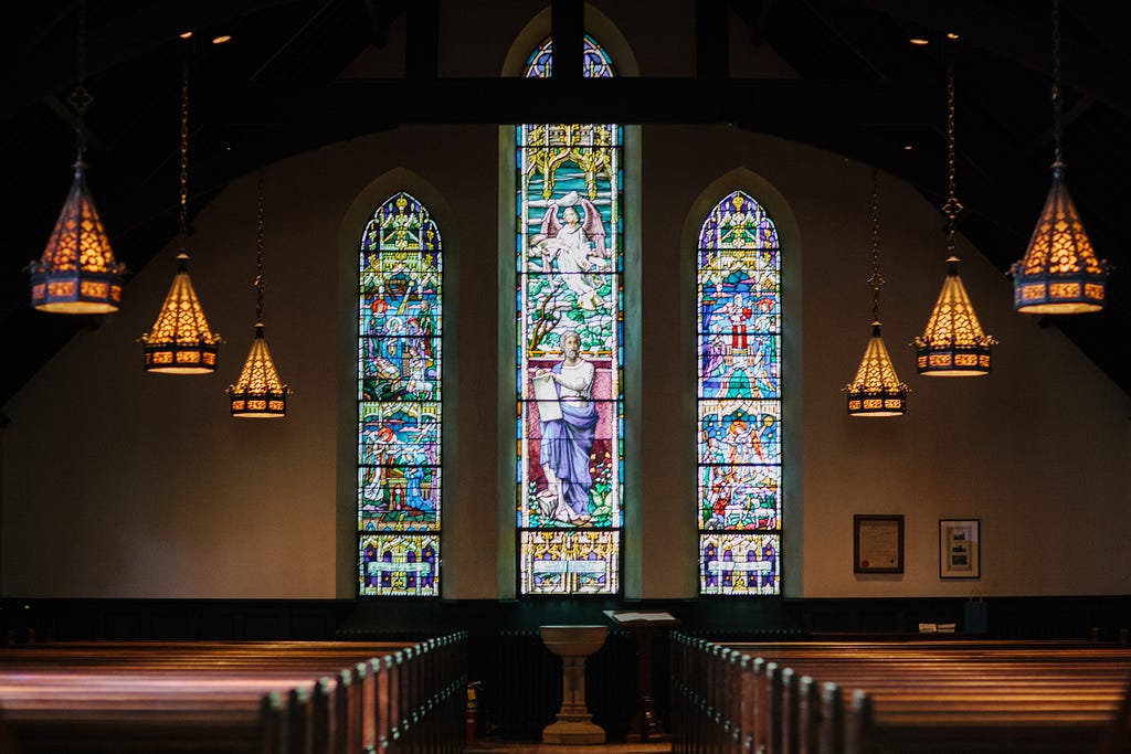 an interior of an empty catholic church