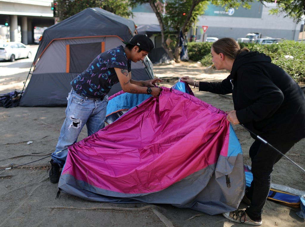 Christina Bojorquez and Kimberly Decoursey pitch a tent in Los Angeles, CA, October 14, 2019. Photo by Lucy Nicholson/Reuters