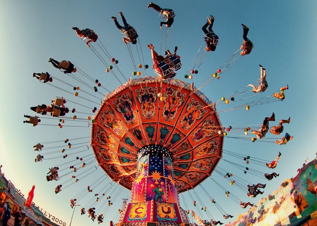 An amusement ride with people riding on it.