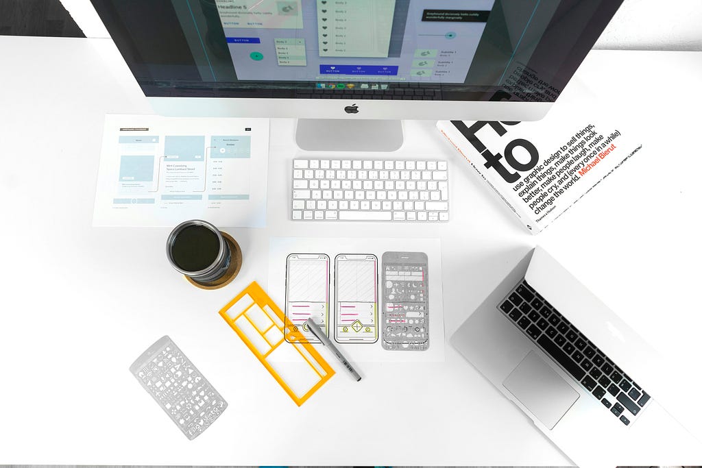 An desk with iPhone Wireframes.