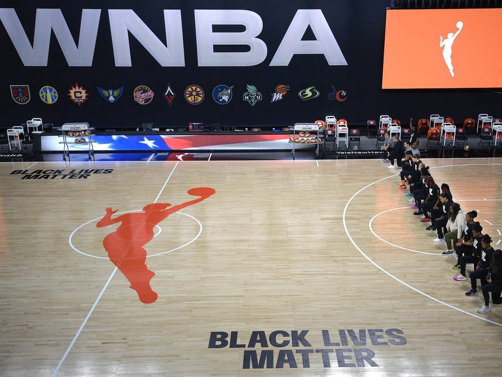 WNBA players kneel during the pregame playing of the national anthem.