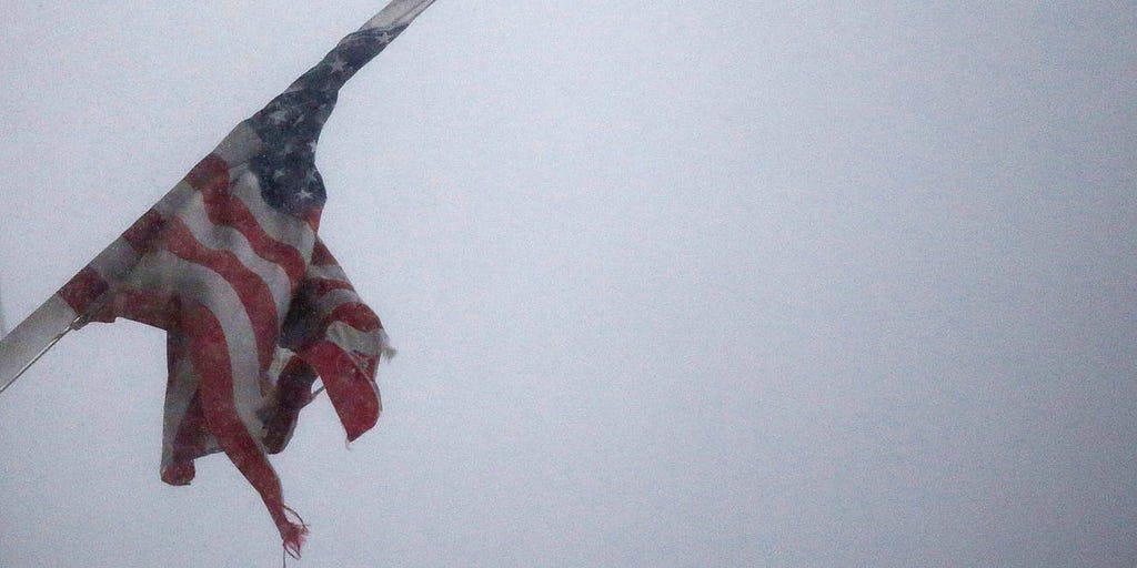 An American Flag flies in blizzard-like conditions on January 23, 2016 in the Brooklyn borough of New York City.