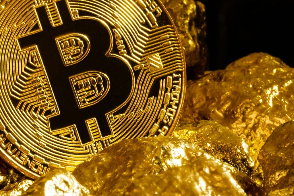 Gold Bitcoin and gold nuggets next to each other