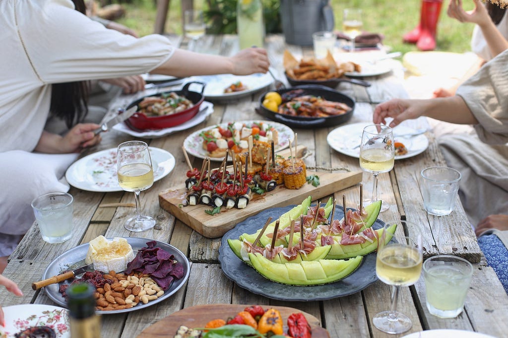 Sober summer: People sat at a table helping themselves to BBQ foods