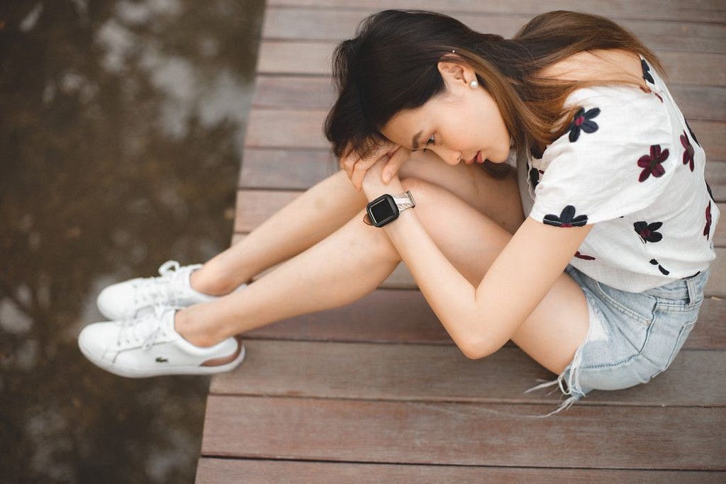 woman overwhelmed by grief sitting at the floor