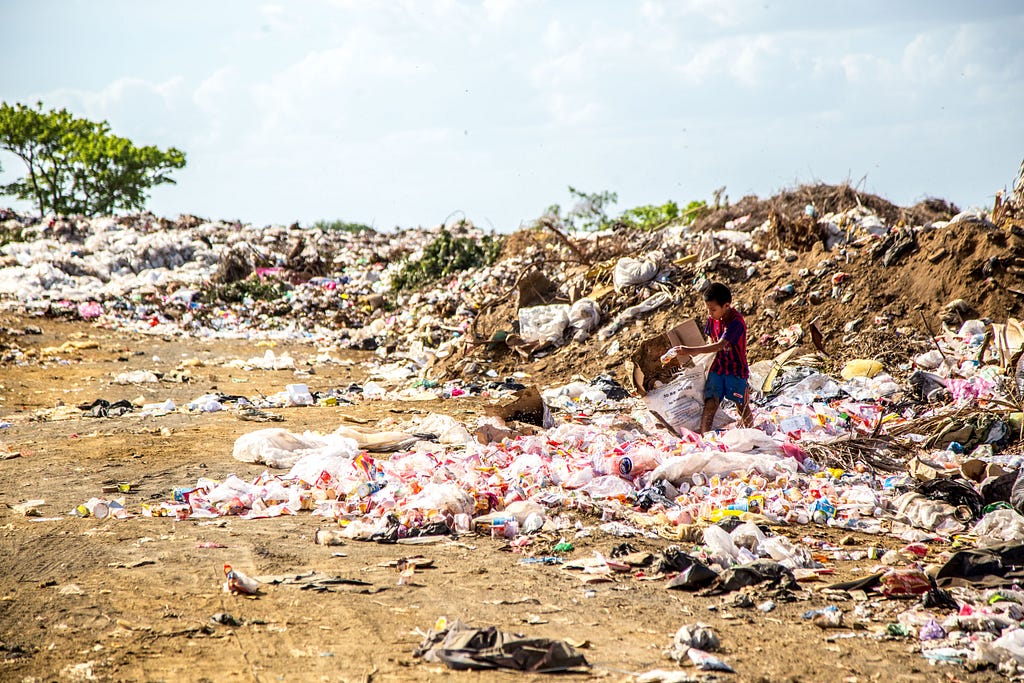 a boy holding trashes