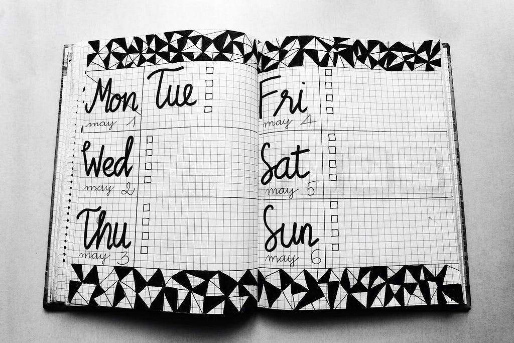 A day planner book opened to a fresh week.