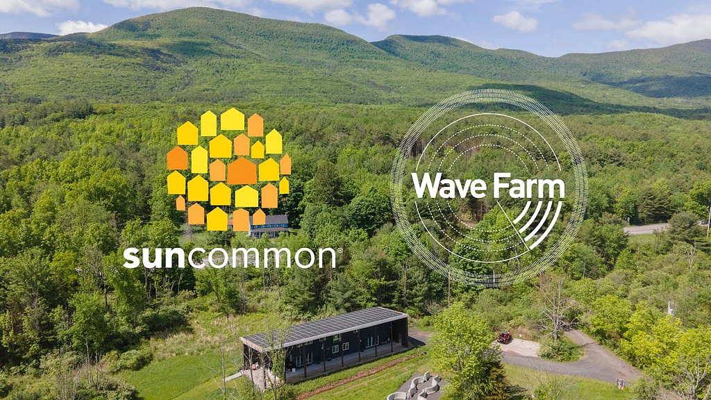 view of the solar suncommon.com logo against the background of green mountains