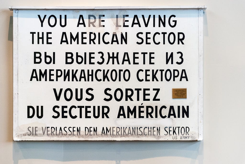 Sign with “you are leaving the american sector” tanslated to multiple languages