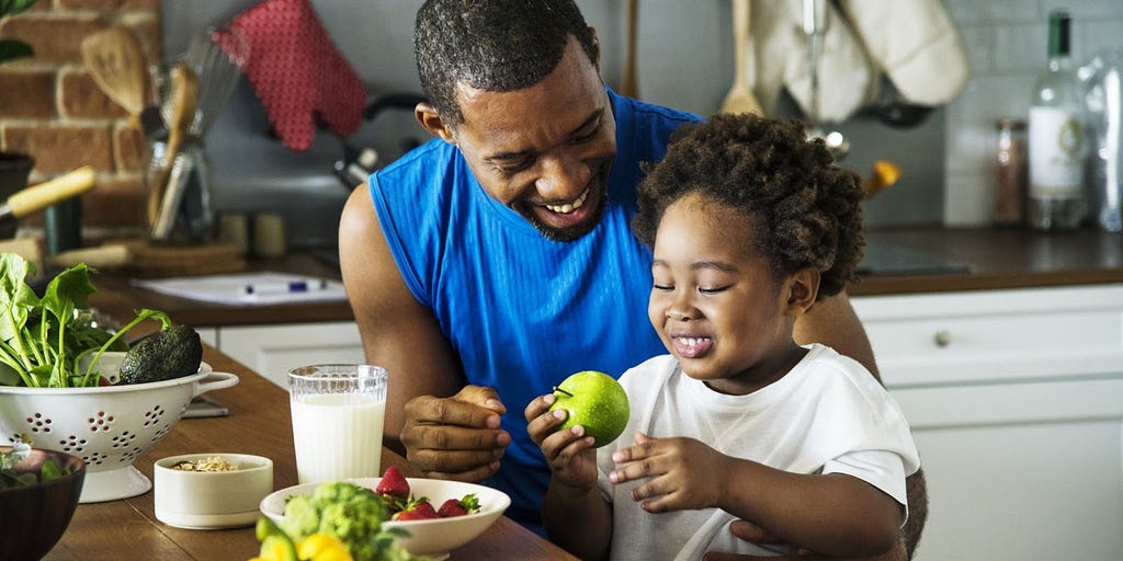 Man and young boy eating healthy food