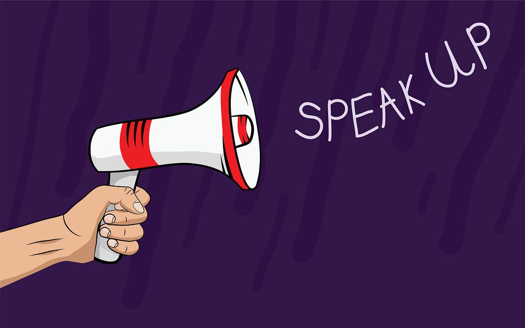 A hand holding a megaphone, sounds " Speak up " 