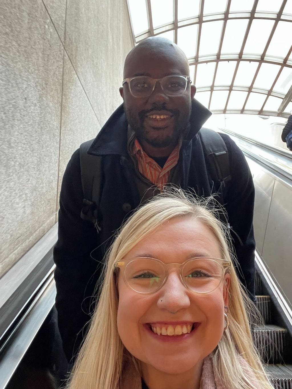 Selfie of Connie van Zanten and Absisola Fatokun on an escalator on the Washington DC metro.