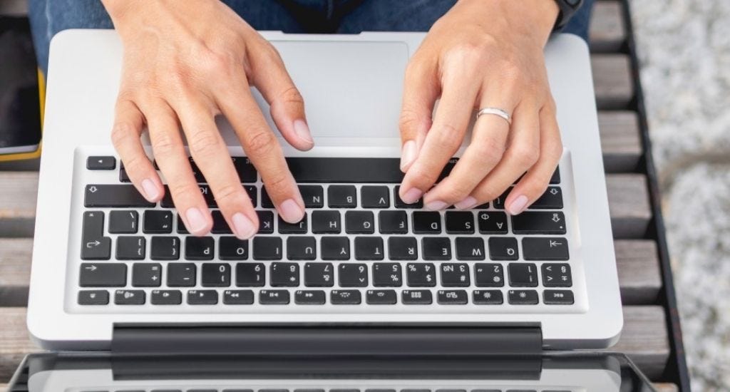 Freelance writer typing on laptop