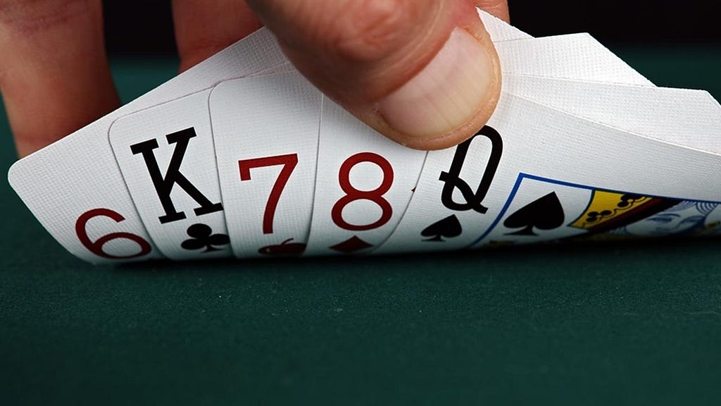 Holding a set of five bad cards during a game of poker.