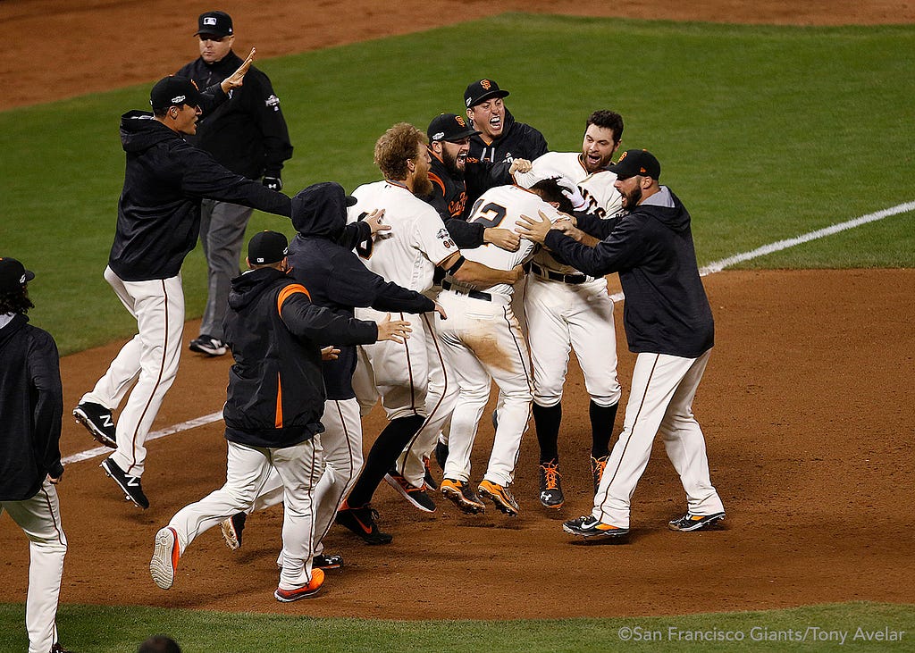 Joe Panik is mobbed after doubling to win the game.