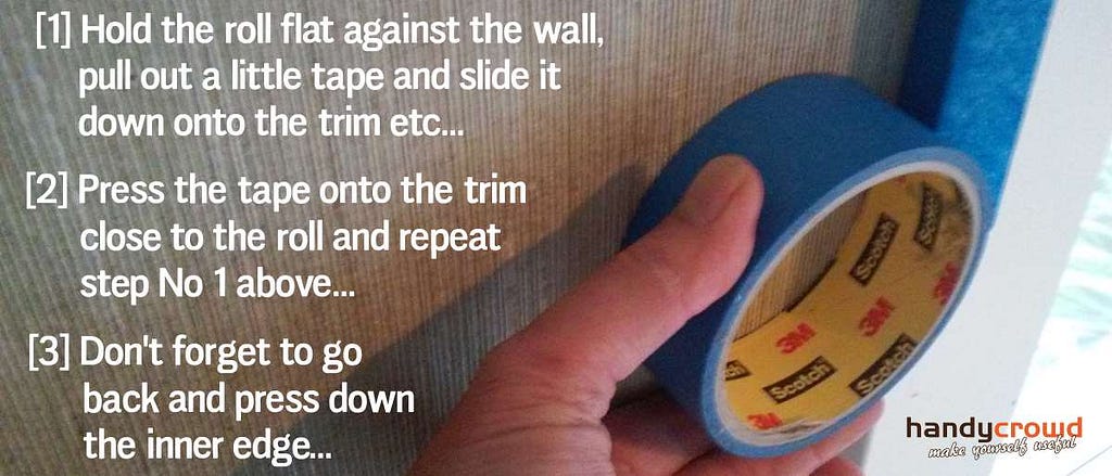 hold blue masking tape roll tight to the wall