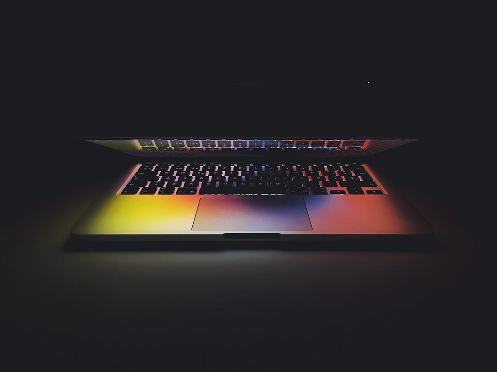Rainbow light reflected on a laptop.