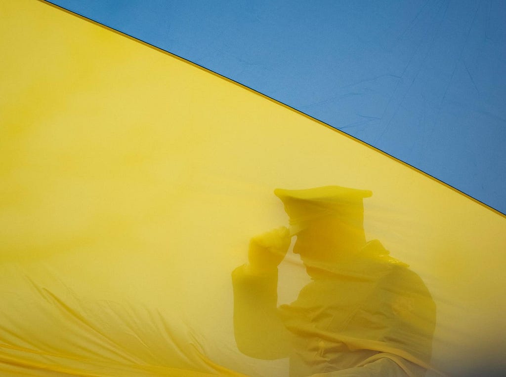 A member of the honor guard prepares during a Ukrainian flag-raising ceremony to mark the first anniversary of the liberation of the town of Bucha, outside Kyiv, March 31, 2023. Photo by Gleb Garanich/Reuters