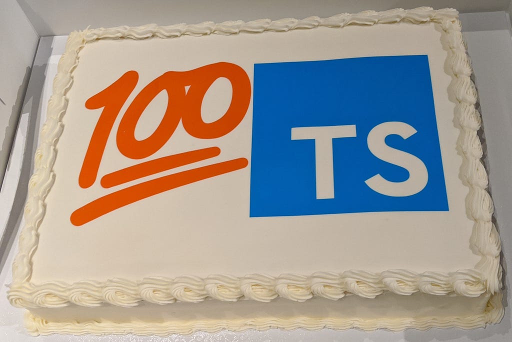 Custom cake printed with the 100 emoji next to the TypeScript logo