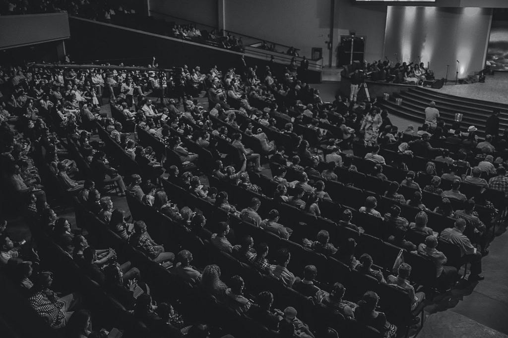 A black-and-white image of a theater audience.