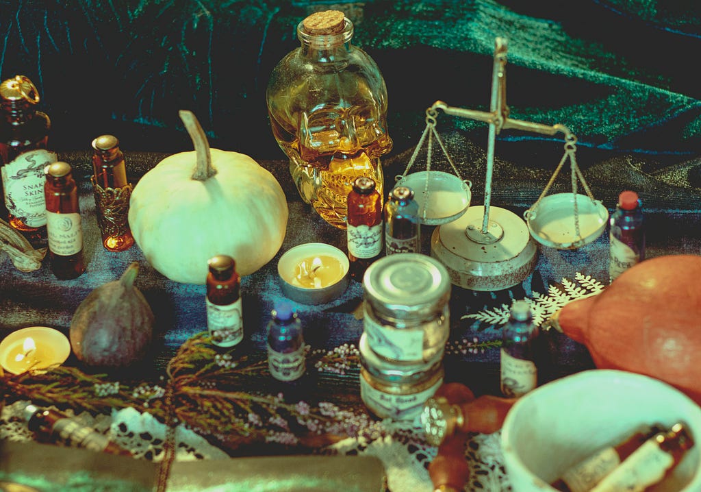 A Pagan altar with the scales of justice, small bottles of oils and herbs