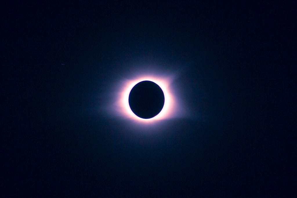 Corona of solar eclipse on a blue-black background