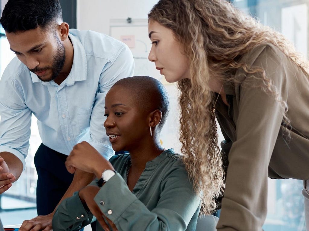 Three people looking at a computer screen. Photo by Anela Ramba/peopleimages.com/Adobe Stock