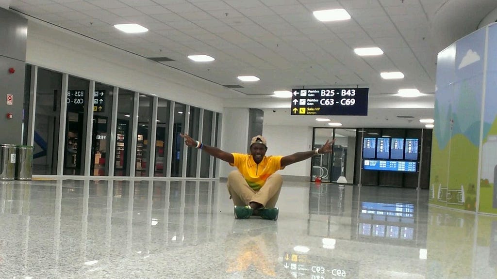 Sydney sitting on the floor by the gate in Rio Galeao Airport before returning home