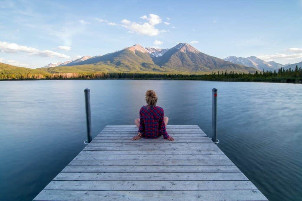 Woman sat by lake