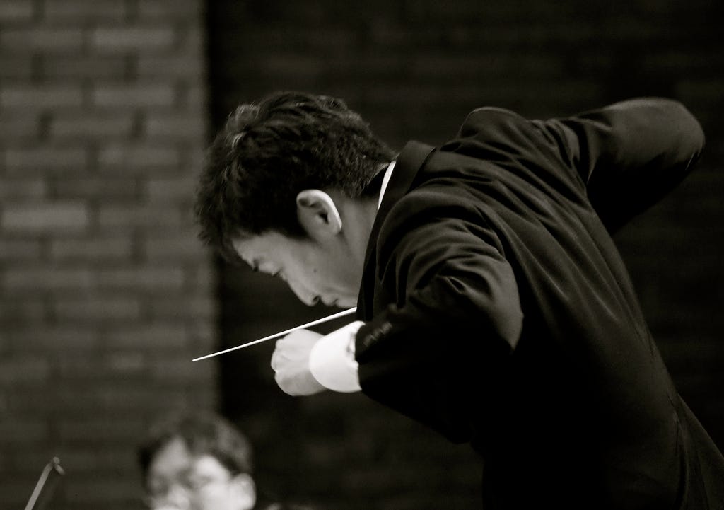 A conductor in a perpetual loop of refinement, iterating to enhance performance.