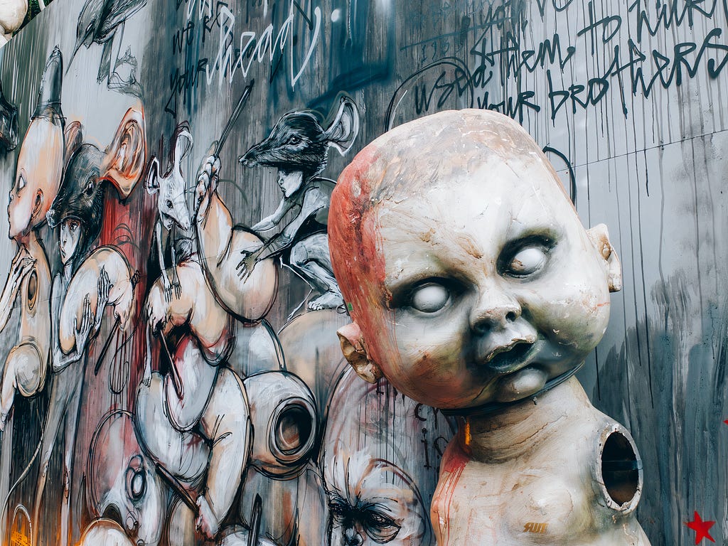 Mixed media art featuring creepy doll parts.