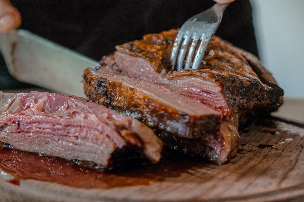 a large steak being cut