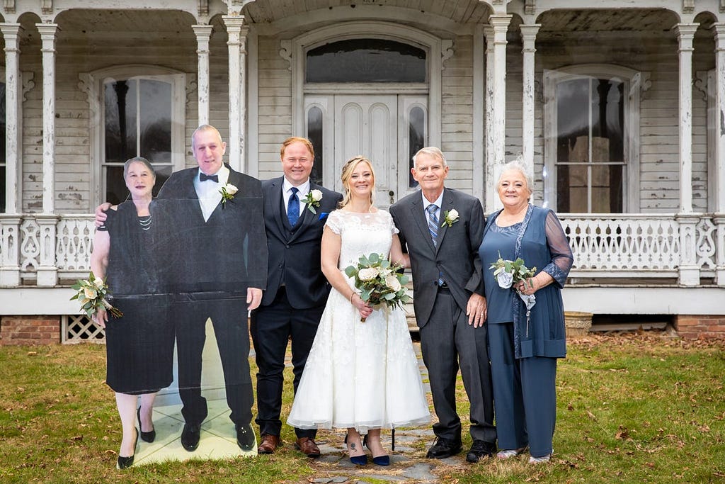 A family with a cardboard cutout.
