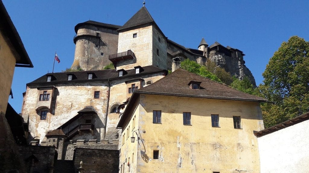 Looking up at Orava castle from the entry courtyard