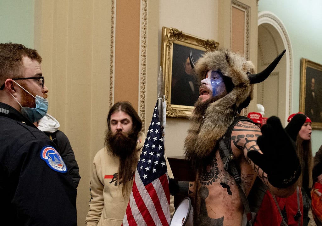 Jake Angeli, the “Q Shaman,” was one of several protesters to confront Capitol police officers on January 6, 2021.