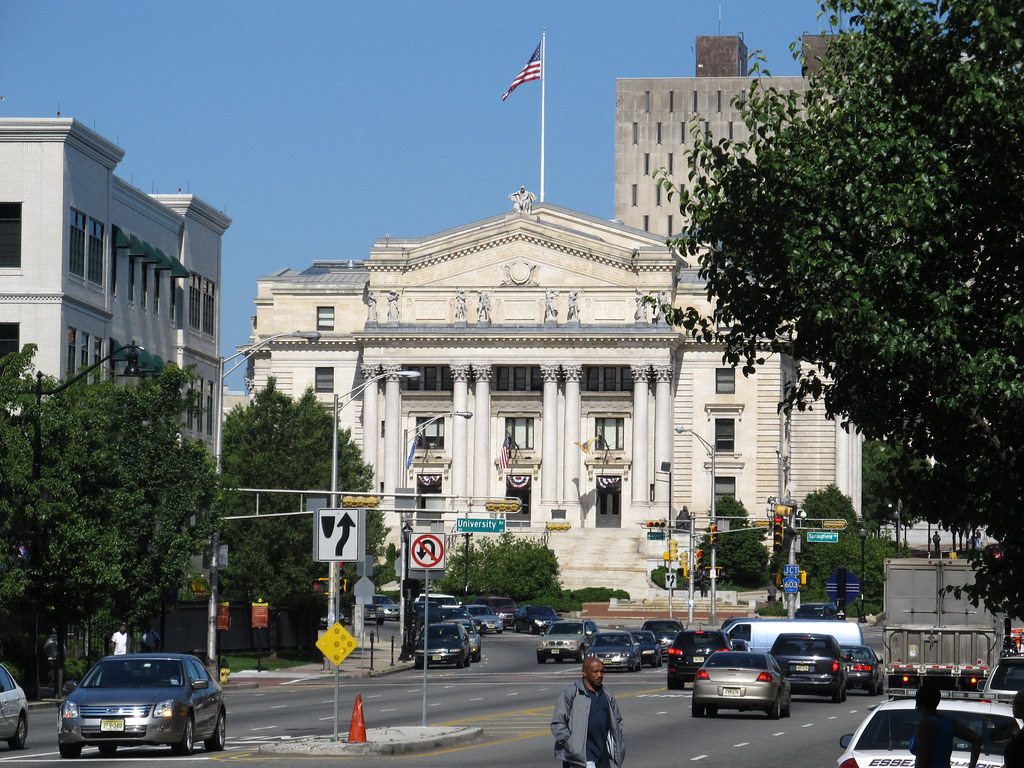 Essex County Court House, an old white building with pillars and an American flag, on a sunny day