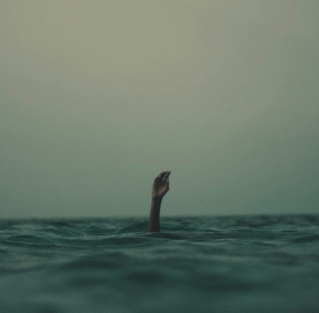 A person drowning in the water.