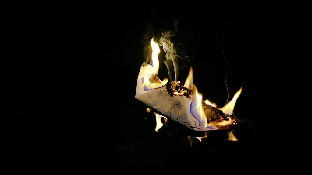 A piece of paper on fire.