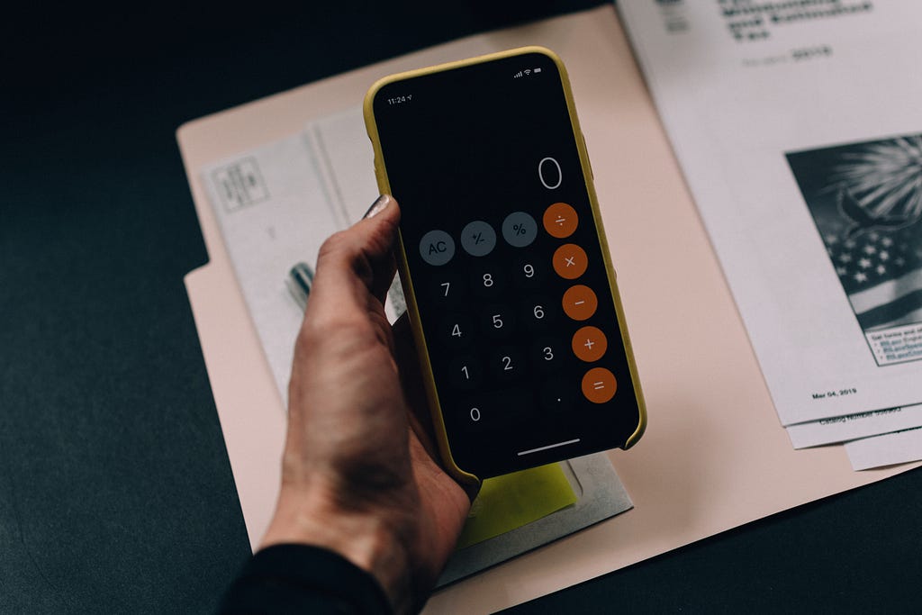 bookkeeper with calculator on phone