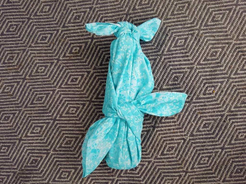 Turquoise wrapping for a small bottle