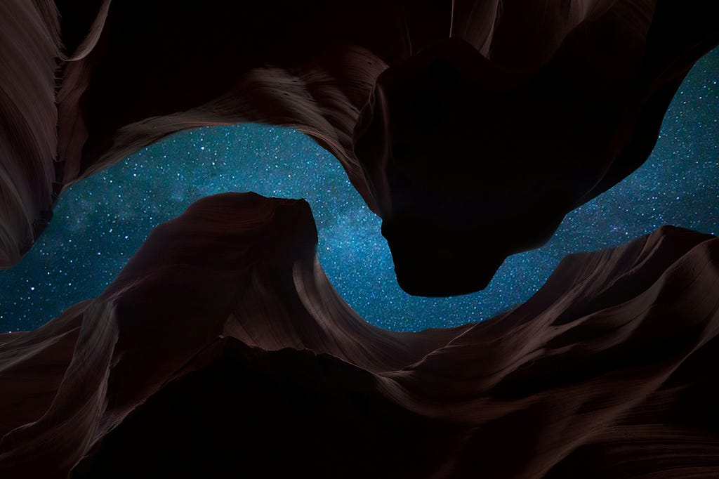 This image depicts the view of the night sky from inside a cave.