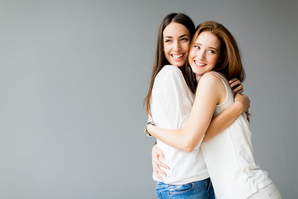 Two women embracing.