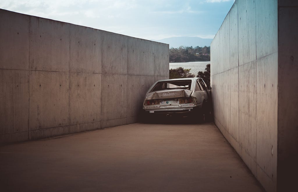 A car that has crashed into two walls